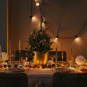 a table with a christmas tree and candles on it